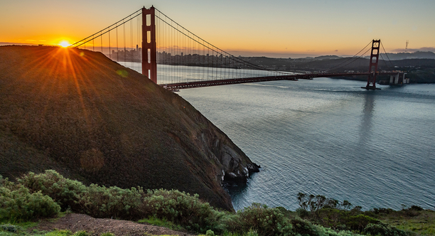 Sun rising over the Golden Gate Bridge from the Marin Headlands.