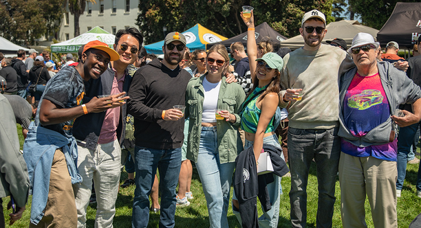 A group of friends line up for a photo at Parks4All: Brewfest, a beer festival and fundraiser, on Saturday, July 29th, 2023 in the Presidio of San Francisco.