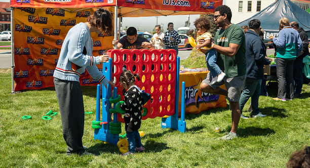 A kid plays Connect Four at Parks4All: Brewfest, a beer festival and fundraiser, on Saturday, July 29th, 2023 in the Presidio of San Francisco.