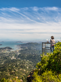 A hiker looks out over the bay from Mount Tamalpais East Peak.