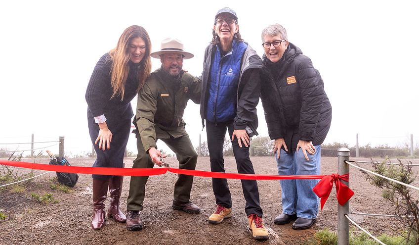 Four people at a ribbon-cutting event for the completion of the Hawk Hill Visitor Improvement Project