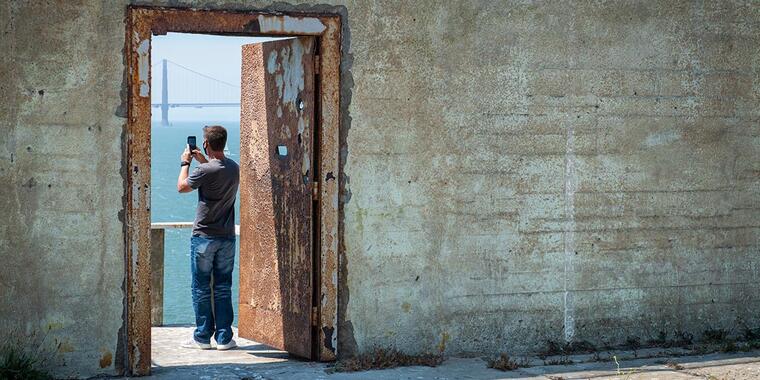 A visitor takes a photo on Alcatraz Island. A visitor takes a photo on Alcatraz Island.