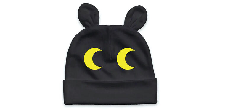 Black and yellow infant cap with animal eyes.