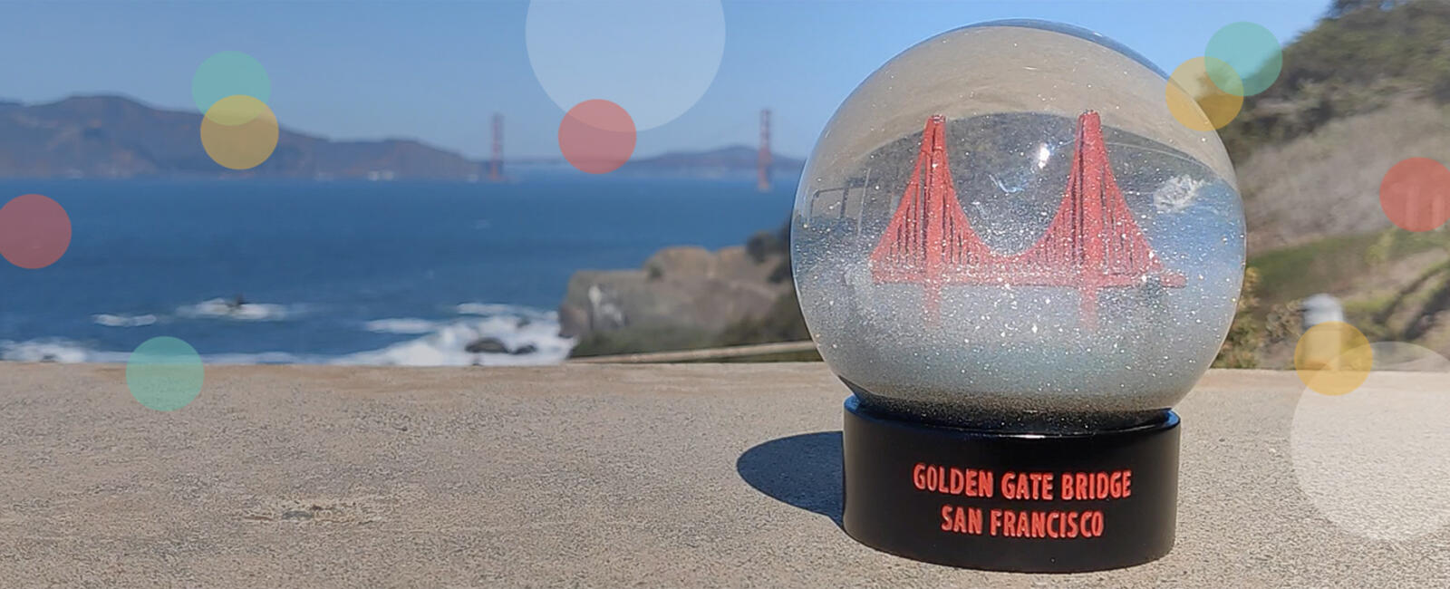 Golden Gate Bridge fog globe with Golden Gate Bridge in the background.