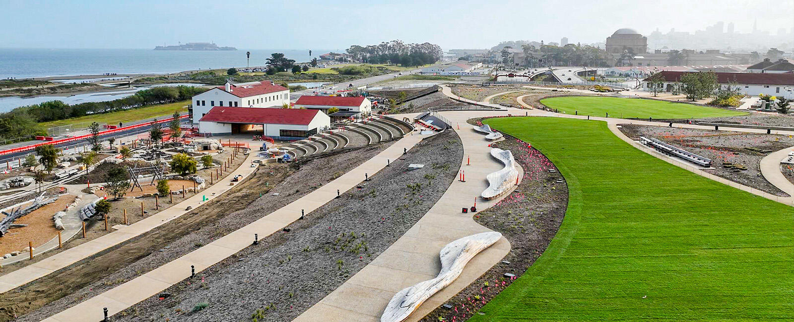 Green lawns, pathways, and buildings at the Presidio Tunnel Tops site.