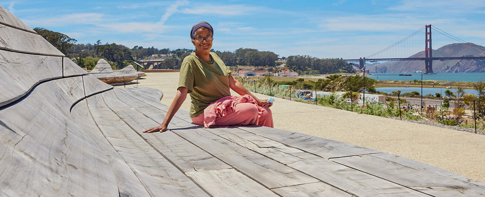 Person sits on cypress wood benches at Presidio Tunnel Tops.