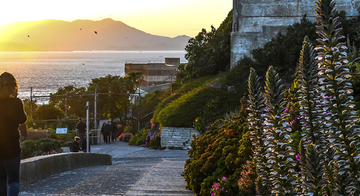 A person walking on Alcatraz Island.