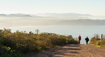People hiking on a trail at Hawk Hill in the Marin Headlands.