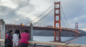 Visitors pause to take photos of the Golden Gate Bridge.