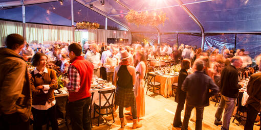A crowd gathered in an elegant dining area for the Trails Forever dinner at Lands End