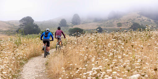 Two cyclists mountain biking a trail in Rancho Corral de Tierra