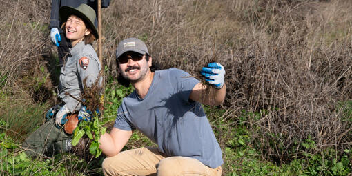 A volunteer strikes a pose while helping to restore Tennessee Valley.