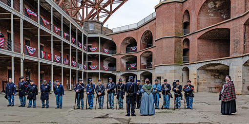 People gathered at Fort Point National Historic Site on Living History Day, dressed in civil war era union uniforms for reenactment.