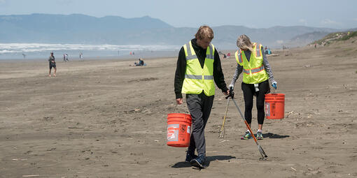 Volunteer removing litter at Ocean Beach