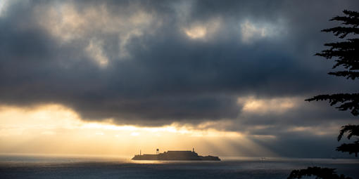 Sunlight breaking through stormy cloud over Alcatraz