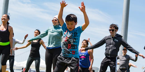 Kid jumping against blue sky