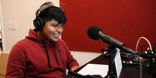 Crissy Field Center IYEL intern speaks into a microphone for a youth program podcast