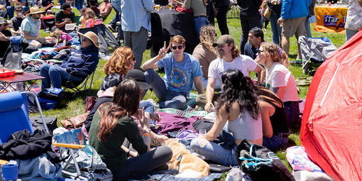 A group of friends sitting on a picnic blanket at Parks4All: Brewfest, a beer festival and fundraiser, on Saturday, July 29th, 2023 in the Presidio of San Francisco.