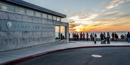 The outside of Lands End Lookout at sunset