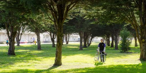 Cyclist rests by the trail through east Crissy Field
