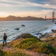 Hiker watching sunset on the Batteries to Bluffs trail