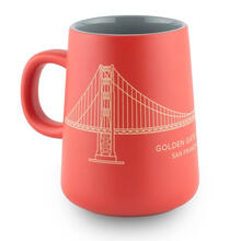 Red and gold tapered mug with a line drawing of the Golden Gate Bridge.