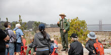 A Golden Gate National Recreation Area Park Ranger leads a discussion at Presidio Tunnel Tops Campfire Circle.