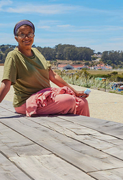 Person sits on cypress wood benches at Presidio Tunnel Tops.