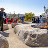 NPS Park Ranger gives a presentation to visitors at the Presidio Campfire Circle